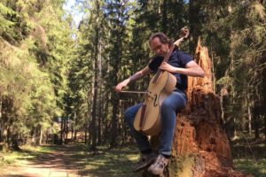 Playing arpeggione in a forest